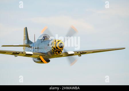 North American P-51 Mustang fighter plane called Janie, flying fast and low. Owned by Maurice Hammond and flown by Dave Evans. Stock Photo