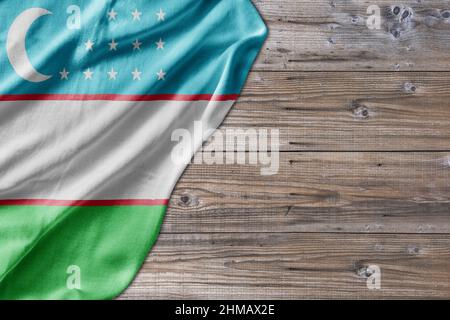 Wooden pattern old nature table board with Uzbekistan flag Stock Photo