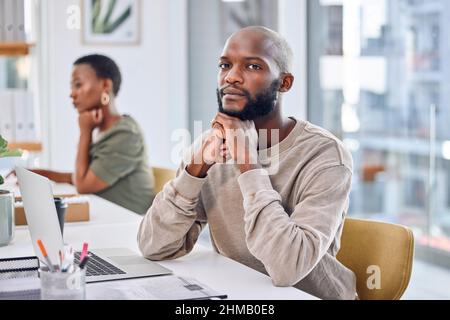 If you want to be successful, hard work is a necessity. Portrait of a confident businessman sitting at his desk. Stock Photo