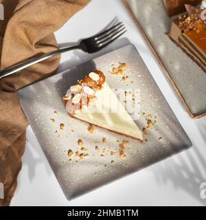 Sliced Cheesecake. Layer of biscuits, mousse based on creamcheese, with raspberry. Healthy dessert. Stock Photo