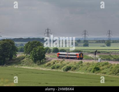 East Midlands trains class 158 express sprinter train passing Allington (west of Grantham) in the countryside with a Norwich to Liverpool train Stock Photo