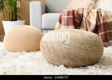 Beige poufs on fluffy carpet in living room Stock Photo