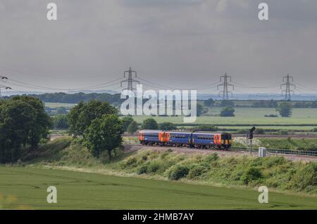 Allington (west of Grantham) East Midlands trains class 156 156411 + class 153 153383 working train 2S23 the 1545 Nottingham - Skegness Stock Photo