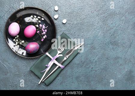 Stylish Easter table setting on dark background Stock Photo