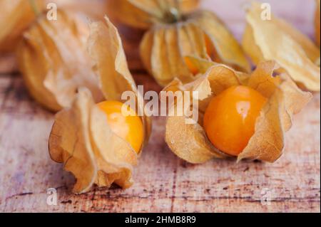 Physalis fruits macro photo on wooden background Stock Photo