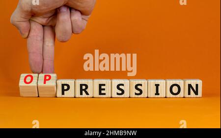 Pression to oppression symbol. Businessman turns wooden cubes, changes the word pression to oppression. Beautiful orange background. Business, pressio Stock Photo