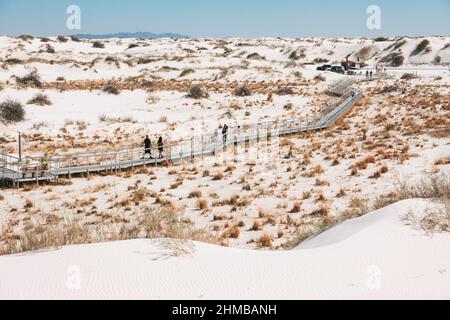Tourists cross on a boardwalk at White Sands National Park, New Mexico, United States Stock Photo