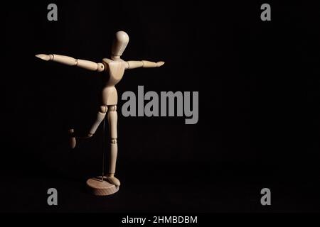 Figure standing on one leg and trying to keep balance. First steps Stock Photo