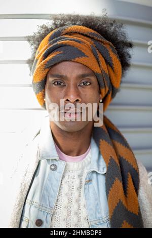 Portrait of young African American man with afro hairstyle and turban. Men's fashion and lifestyle concept. Stock Photo