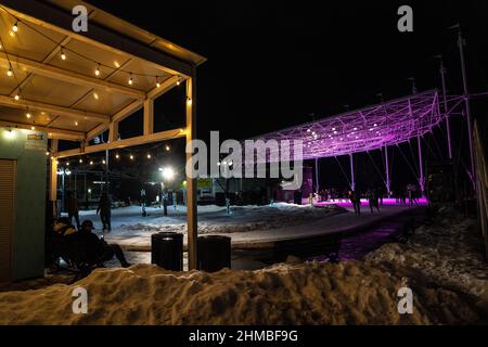 Toronto, Canada. 07th Feb, 2022. People skate along a brightly-lit outdoor ice rink. The Nordic Lights outdoor winter exhibition, a display of Nordic and Canadian light art at the Toronto Harbourfront Centre, co-produced with Fjord Studio. Credit: SOPA Images Limited/Alamy Live News Stock Photo