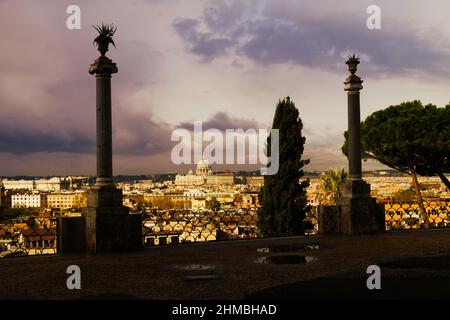 Landscape from Pincio Hill on roofs and churches of the ancient city of Rome. Far away St. Peter's Basilica. Stock Photo