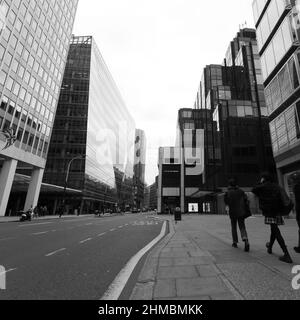 London, Greater London, England, February 05 2022: Victoria Street architecture and pedestrians in black and white Stock Photo