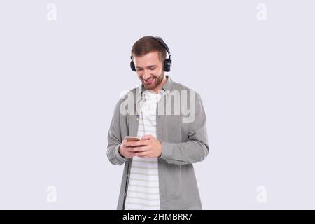 Man Listening to Music from Phone Chatting. Man Holding Phone. Isolated Stock Photo