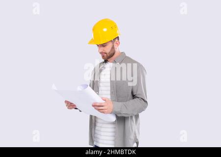 Construction Worker Looking at House Plan. Architect Holding Blueprints. Yellow Hard Helmet. Worker Stock Photo
