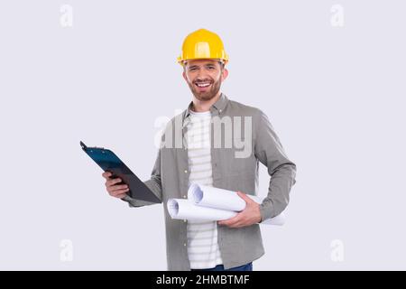 Construction Worker Holding House Plan and Clipboard in Hands. Architect Holding Blueprints. Yellow Hard Helmet. Worker Smilling Stock Photo
