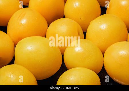 Lots of fresh yellow plums on a black background, close-up macro Stock Photo