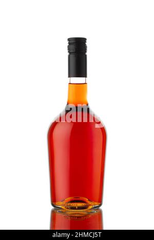 front view closeup of round traditional shape cognac brandy or whisky bottle with no label isolated on white background with reflection Stock Photo