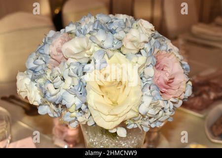 Close up of brides  bouquet of flowers in pastel colours, blue hydrangea, pink and cream roses Stock Photo