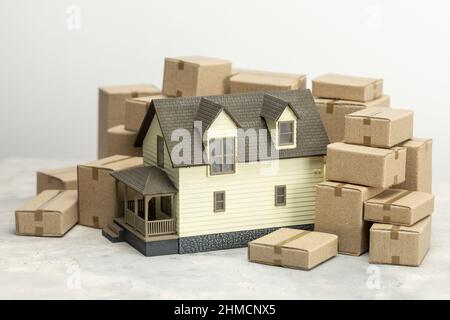 Moving day. House and cardboard boxes for moving. Stock Photo