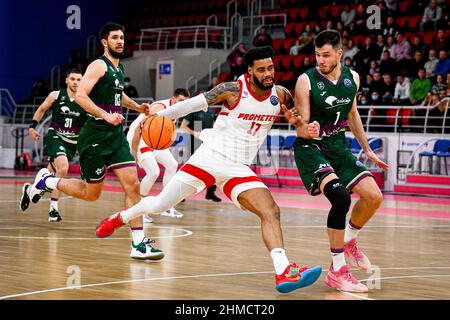 ZAPORIZHZHIA, UKRAINE - FEBRUARY 8, 2022 - Shooting guard D.J. Kennedy of BC Prometey (C) and small forward Jonathan Barreiro (R) of BC Unicaja are se Stock Photo