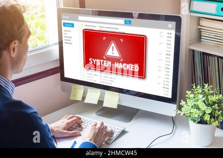 System hacked alert on computer screen after cyber attack on network. Cybersecurity vulnerability on internet, virus, data breach, malicious connectio Stock Photo