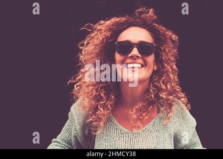 Happy cheerful attractive young adult woman portrait with black background for copy space. Middle age female people smiling and laughing a lor. Brown Stock Photo