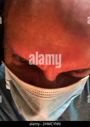 Augusta, Ga USA - 12 20 20: Man wearing face mask close up squnited eyes Stock Photo