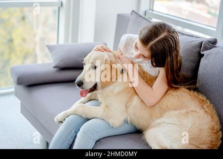 Sweet girl holding cute dog Stock Photo