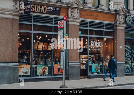 London, UK - October 23, 2021: People walking past Soho Coffee Co coffee shop in the City of London, the capital's famous financial district. Stock Photo