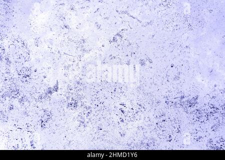 Surface of polished flat tile of weathered travertine with natural imperfections. Real stone is toned in very peri, color of year 2022. Large copy spa Stock Photo