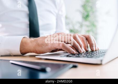 Closeup shot of businessman typing laptop keyboard, selective focus Stock Photo
