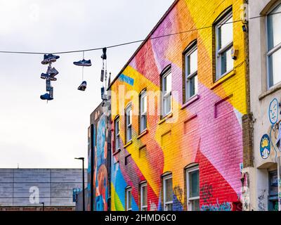 Chance Street, wall artwork, Shoreditch. shoes hanging wire. Stock Photo