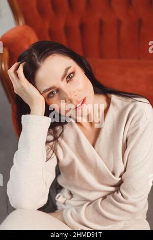 Woman indoor portrait. Young beautiful woman in warm cashmere clothes at home. fashion. Autumn, winter Stock Photo