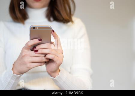 Smartphone image of a woman's hand holding mobile phone Stock Photo