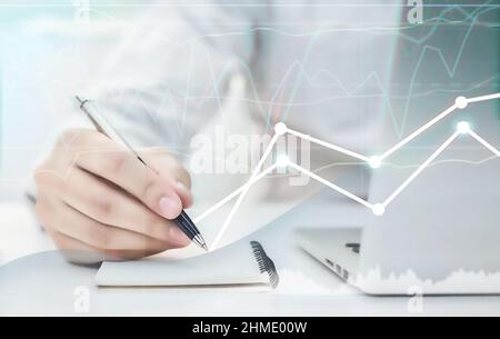 Stock chart analysis. Fundamental analysis, a type of working businessman. Online trading Stock Photo