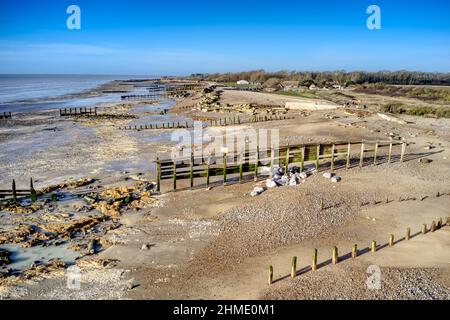 An old isolated wooden groyne and sea defence on a beach in Southern England after storm damage. Stock Photo