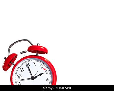 Red alarm clock against white background, daylight saving time changeover Stock Photo