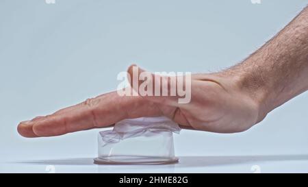 partial view of man pressing plastic cup on gray, zero waste concept Stock Photo