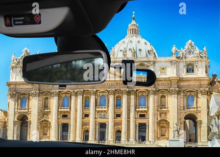 Looking through a dashcam car camera installed on a windshield with view of Saint Peter's Church, iconic Cathedral in Rome, Italy Stock Photo