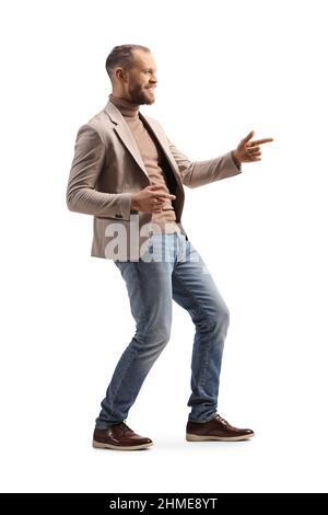 Full length profile shot of a young man dancing and gesturing with fingers isolated on white background Stock Photo
