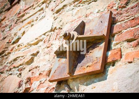 Old brick wall reinforced with metal plates Stock Photo