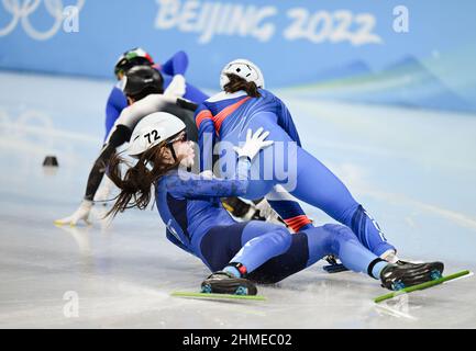 Beijing, China. 9th Feb, 2022. Olga Tikhonova (front) of Kazakhstan falls onto the ice rink during the women's 1,000m short track speed skating heats at Capital Indoor Stadium in Beijing, capital of China, Feb. 9, 2022. Credit: Li Ga/Xinhua/Alamy Live News Stock Photo