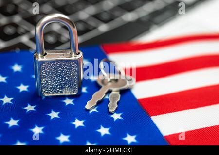 USA cyber security concept. Padlock on computer keyboard and American flag. Close-up view Stock Photo