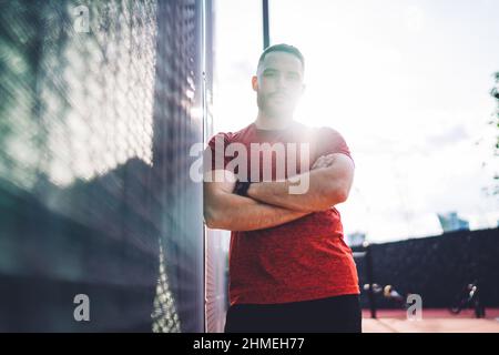 Young man standing against wall Stock Photo