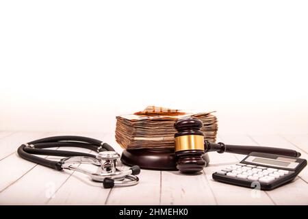 Compensation and judge's gavel. Award of moral financial compensation for caused damage. Lawyer services. Workers rights protection. Raising wages Stock Photo