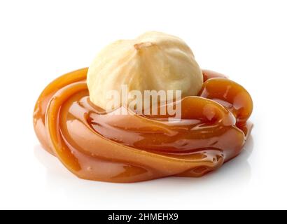 hazelnut in melted caramel macro isolated on white background Stock Photo
