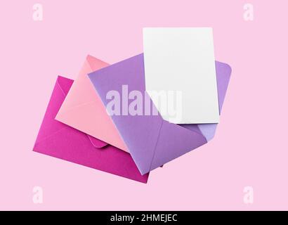 Greeting card mockup in open envelope. Valentines day concept. Envelopes on pink background. High quality photo Stock Photo