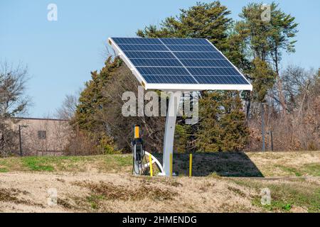 Horizontal shot of an electric vehicle charging station powered by solar energy. Stock Photo
