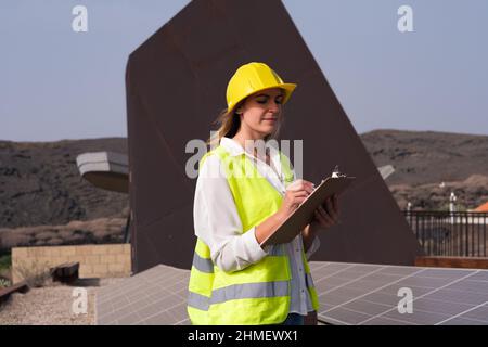 woman engineer checking the solar panels Stock Photo