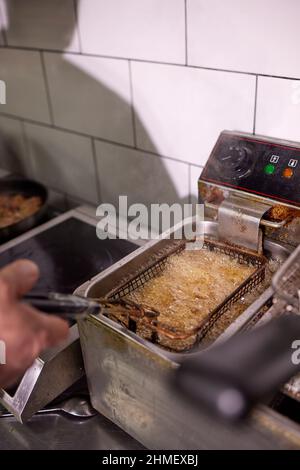 Dirty cooking area with french fries deep fryer Stock Photo